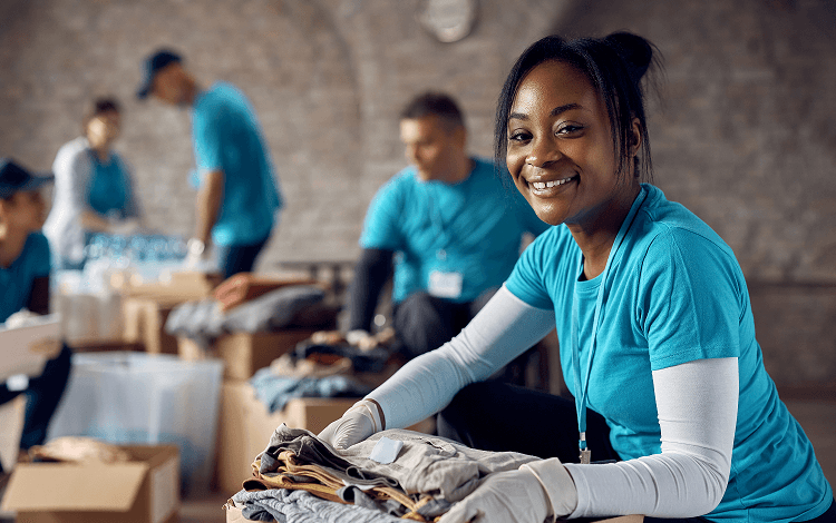 Happy black female volunteer with donation box